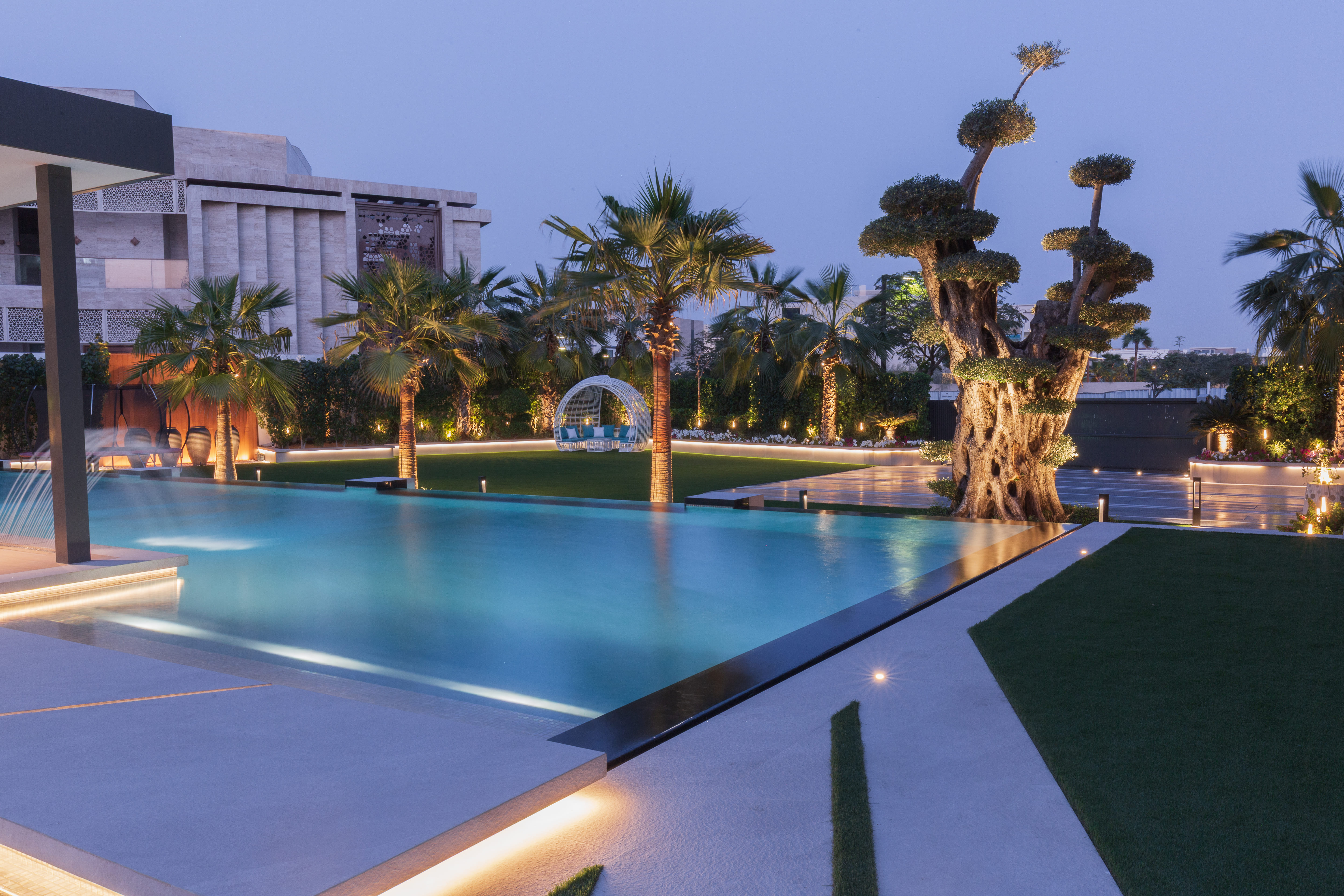 Illuminated pool landscape at dusk