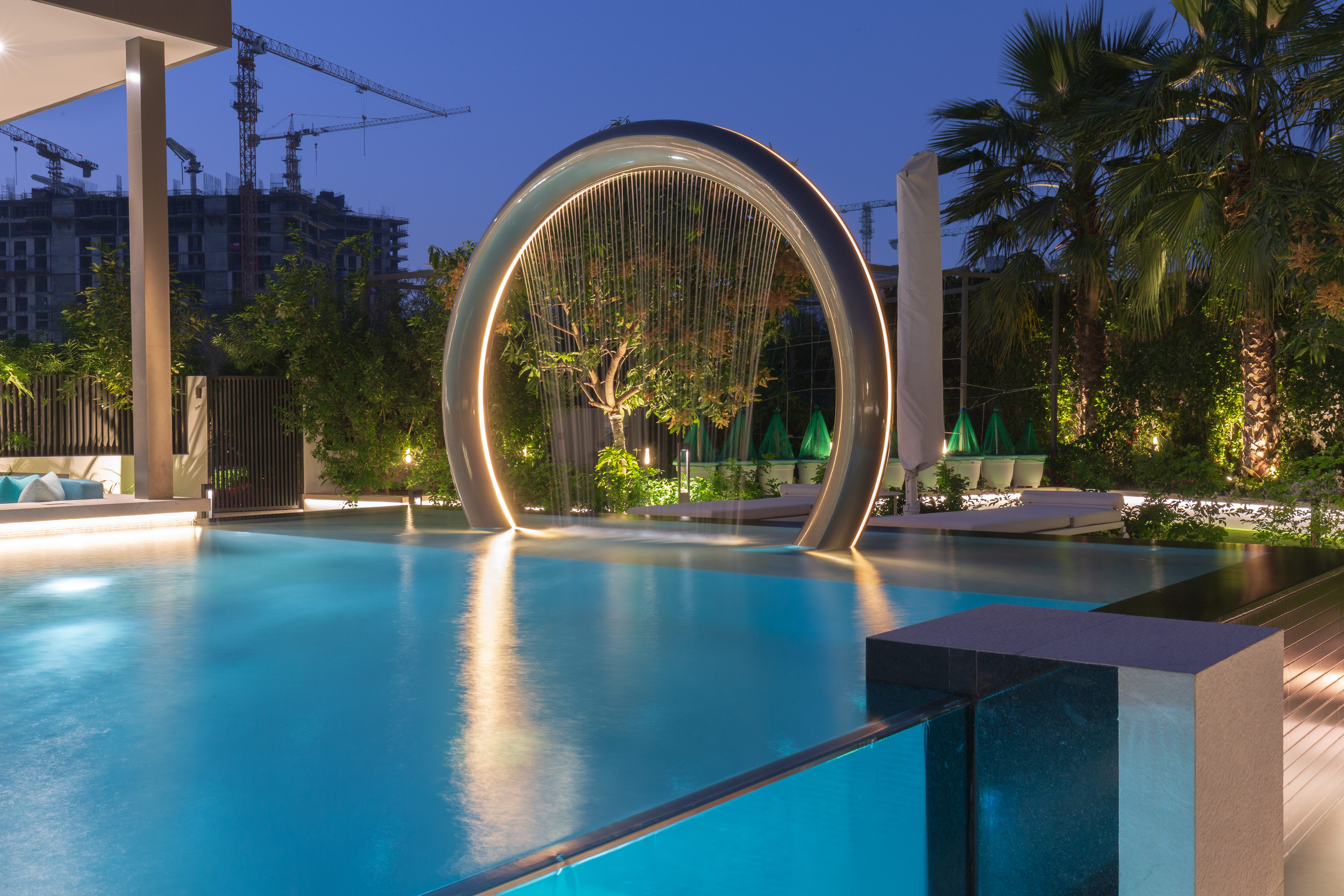 Resort-style pool glowing after dark