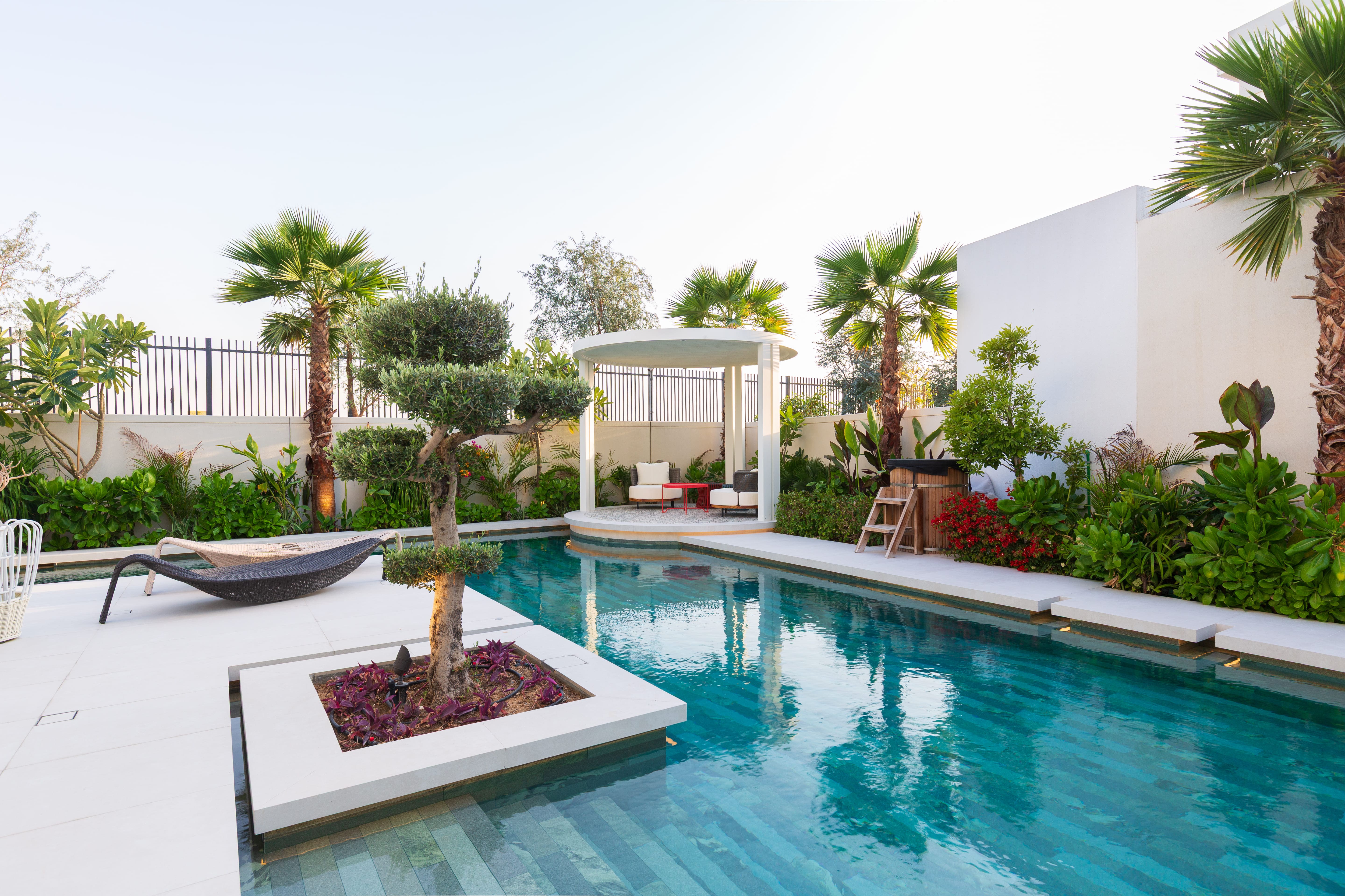 Modern villa garden with pool and tropical planting