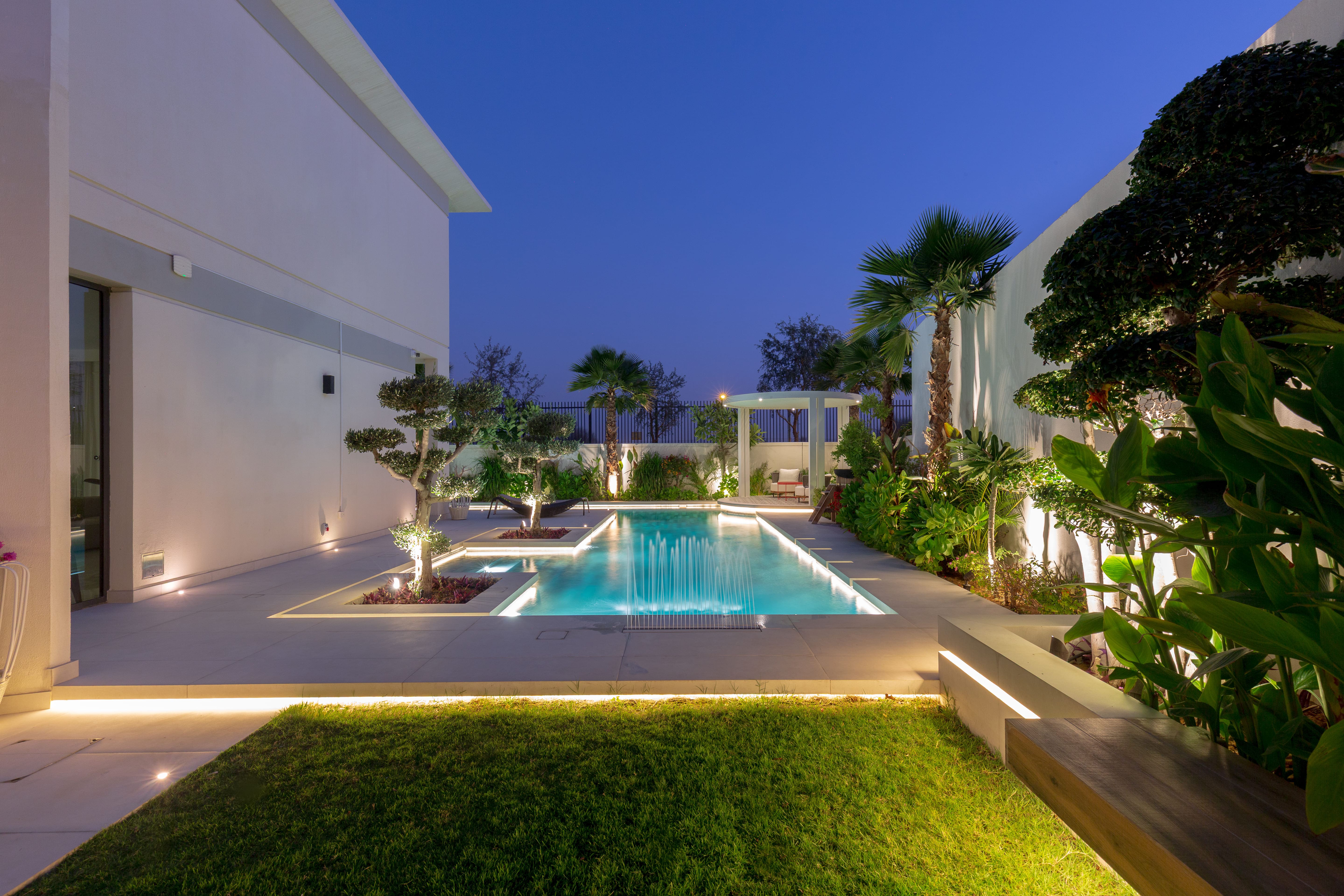 Architectural landscape lighting around the garden pool
