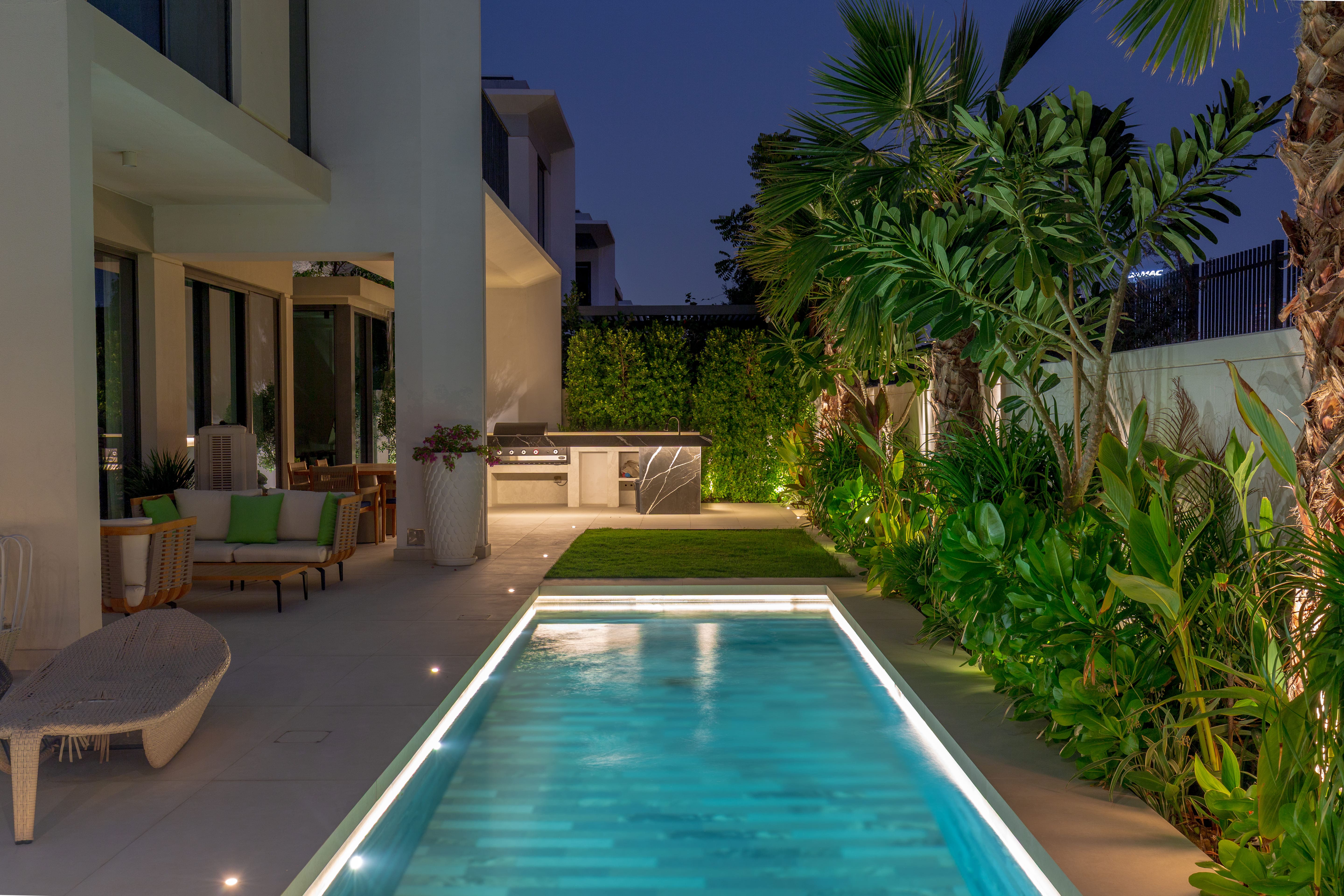 Circular garden pavilion beside a luxury villa pool